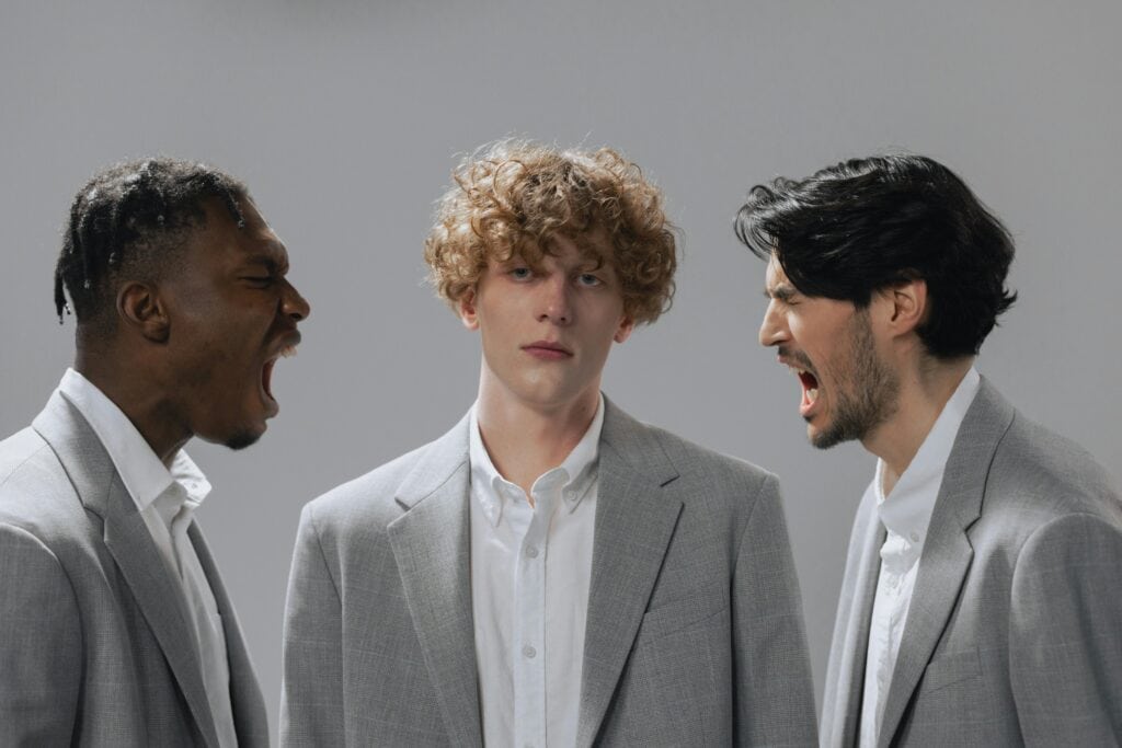 Man wearing grey suits two of them are shouting